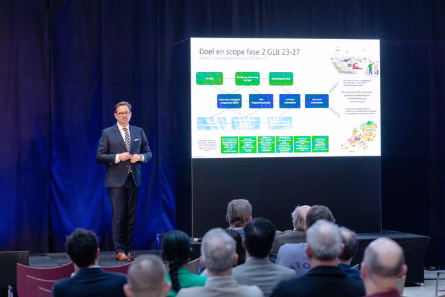 Speaker presents the objective and scope of phase 2 GLB 23-27